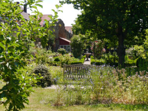 Blick zum Gartenhaus und Sichtachse Rosenpavillons im Garten Schlegelmilch